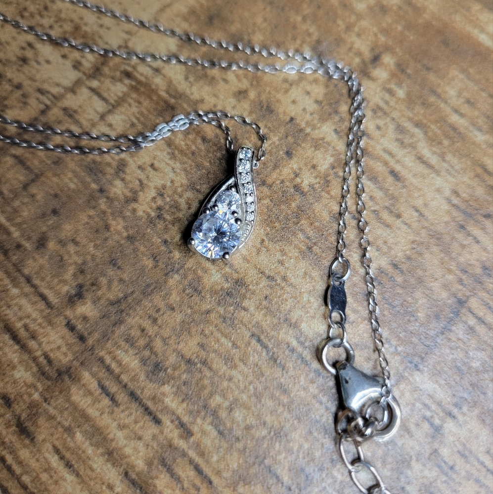 delicate silver chain and diamond pendant